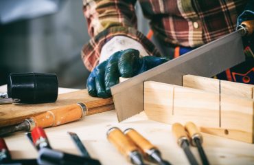 Carpenter holding a hand saw